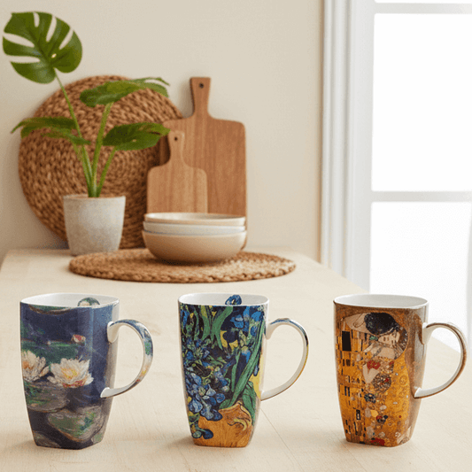 Grande mugs showcased on a kitchen counter with prints of Claude Monet's, Water Lilies, Van Gogh's, Irises and Gustav Klimts, The Kiss.
