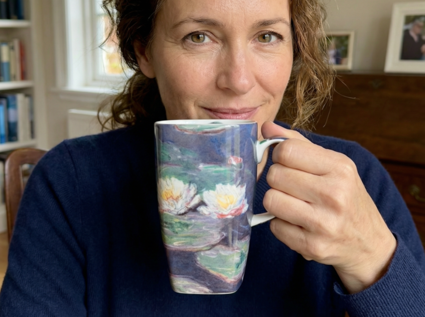 Women holding a coffee mug with Waterlilies design
