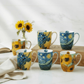 Set of six mugs with Van Gogh artwork designs on kitchen counter featuring two of each of the iconic paintings Starry Night, Sunflowers and Irises by the legendary Vincent van Gogh.