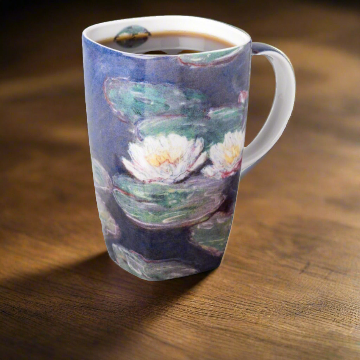 Claude Monet Water Lilies Grande Mug, lifestyle image styled on a table with coffee