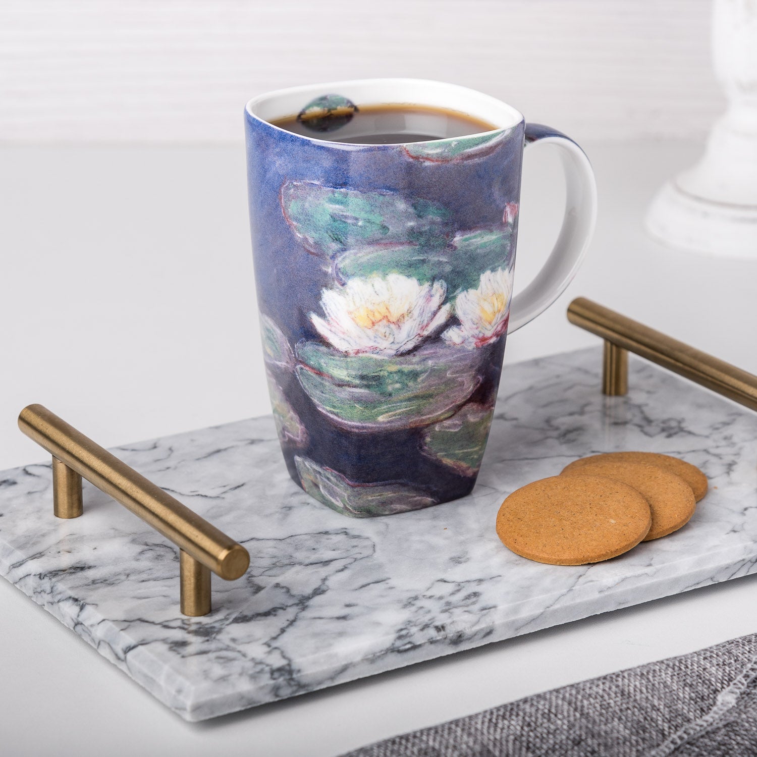 Claude Monet Water Lilies Grande Mug, lifestyle image styled in a kitchen setting with coffee and cookies